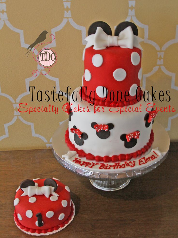 a red and white cake sitting on top of a table next to a minnie mouse cake