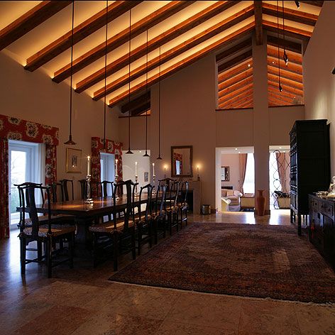 a large dining room with wooden ceiling beams