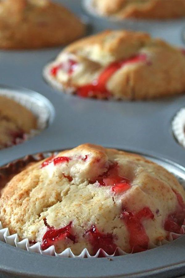 muffins with strawberries are sitting in the pan