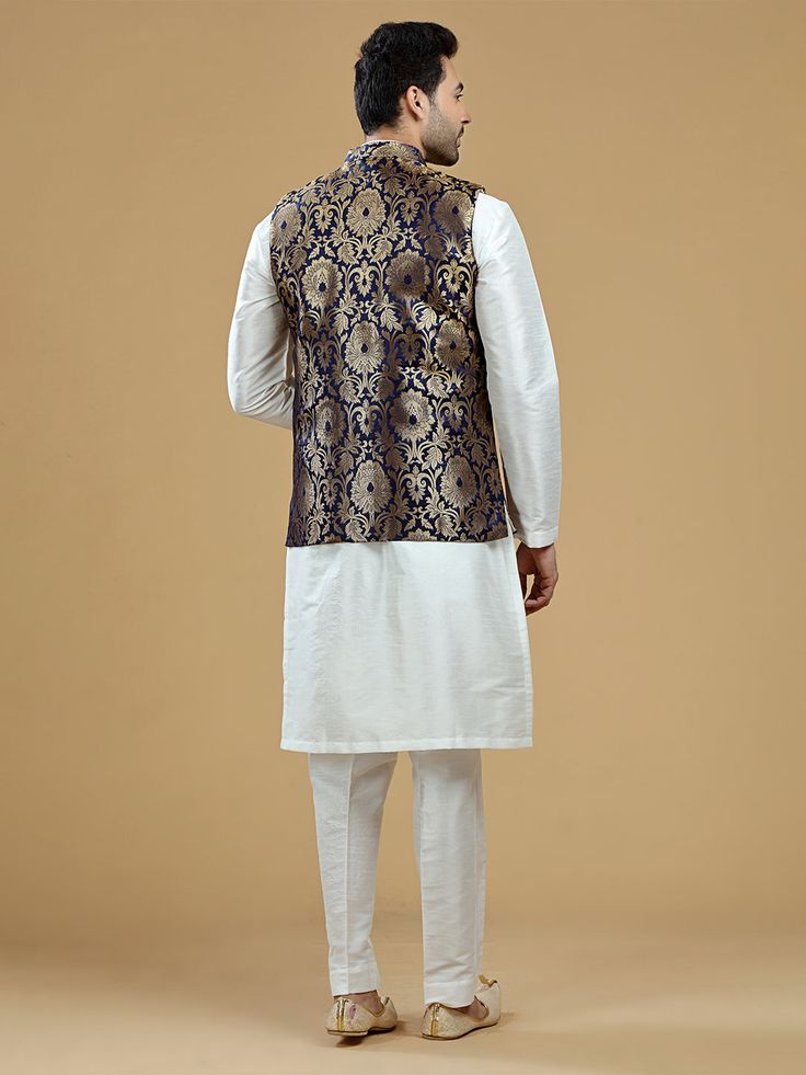 A gold zari brocade vest to pair with any kurta with statement button closures at the front. Occasion: Style this vest with pajama pants and a kurta for a welcome dinner or sangeet night, or style it with a any dress shirt and trousers for a sleek Indian wedding reception look! WASH CARE INSTRUCTIONS - Please Dry clean only. Slight color variation is possible due to digital photography. **Kurta & Pajama not included Sleeveless Nehru Jacket With Zari Work For Transitional Season, Sleeveless Bandhgala For Eid, Designer Sleeveless Kurta For Transitional Season, Sleeveless Nehru Jacket For Diwali, Designer Sleeveless Kurta For Eid, Brocade Nehru Jacket For Diwali Designer Wear, Bollywood Brocade Nehru Jacket For Festive Occasions, Diwali Brocade Nehru Jacket For Designer Wear, Diwali Designer Brocade Nehru Jacket