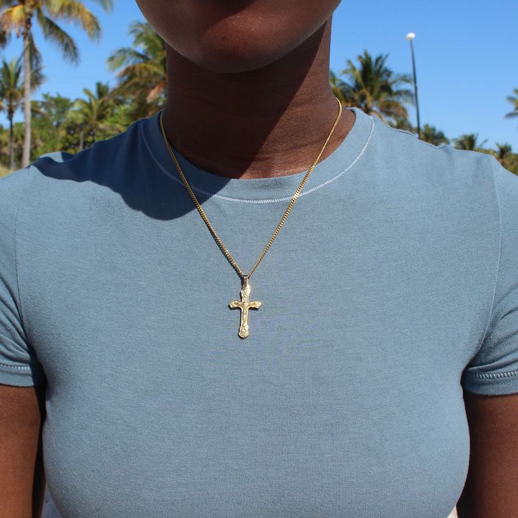 Our detailed cross pendant is placed on our 1mm cable chain for a simplistic touch to the necklace. This necklace is great to be worn as a statement piece in a layered look. We recommend pairing with The Angel Chain in 16" and The Beloved Chain in 18". Stainless Steel 18k Gold Plated Hypoallergenic Pendant size: 3.3" x 1.9" Chain width: 2.2mm Chain length: 18" with 2" extender Gold Cross Necklace With Figaro Chain, Figaro Chain Cross Pendant Necklace For Gift, Crucifix Cross Necklace With Figaro Chain As Gift, Detailed Cross, Silver Shop, The Angel, Chain Ring, Layered Look, The Cross