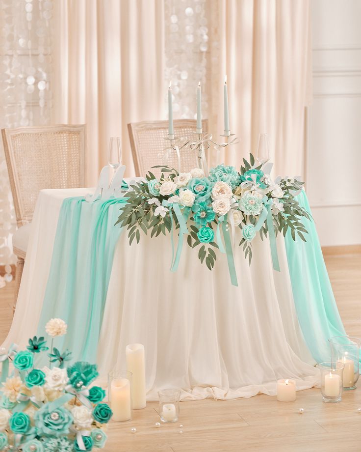 the table is decorated with flowers and candles