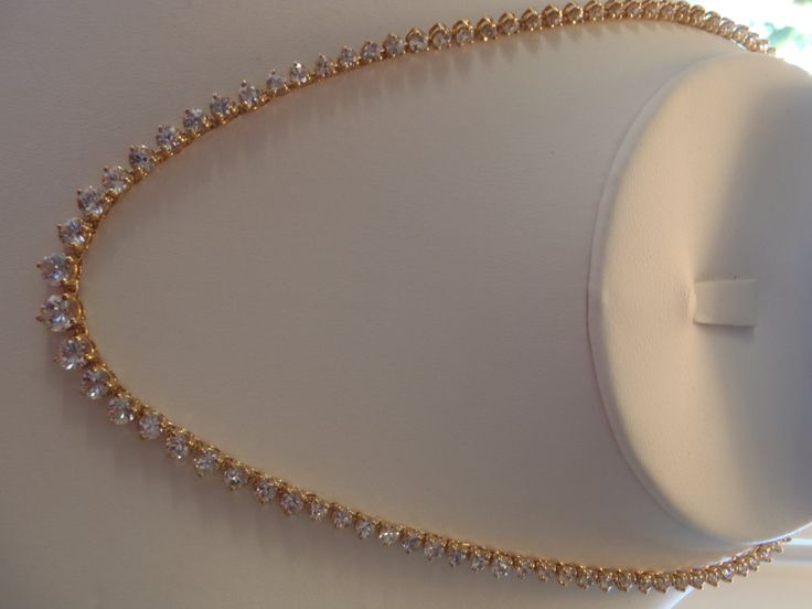 "ALL HANDMADE 14K SOLID YELLOW GOLD NECKLACE WITH 105 GRADUATED ALL NATURAL, MINED WHITE SAPPHIRES - NOT LAB CREATED. GUARANTEED. RECENTLY APPRAISED BY A GIA GRAD GEMOLOGIST. ABSOLUTELY STUNNING, WORN ONLY A HANDFUL OF TIMES. I AM THE SOLE OWNER. IT HAS A SECURE TONGUE CLASP CLOSURE & WRAP-AROUND CATCH THAT SNAPS SHUT TIGHTLY FOR ADDITIONAL SECURITY. Approximately 57 carats total of sapphires. Largest stone approx. 6 mm and smallest approx. 2.5mm. VS clarity. Total gram weight for the neckla Formal 14k Yellow Gold Tennis Necklace, Gold Cubic Zirconia Bridal Necklace With Diamond Cut, Gold Tennis Necklace With Diamond Accents As A Gift, Gold Round Tennis Necklace For Gift, Gold Bridal Necklace For Anniversary Fine Jewelry, Gold Single Strand Necklace For Formal Occasions, Luxury Gold Bridal Necklace For Anniversary, Formal Gold Single Strand Necklace, Gold Tennis Necklace With Prong Setting As Gift