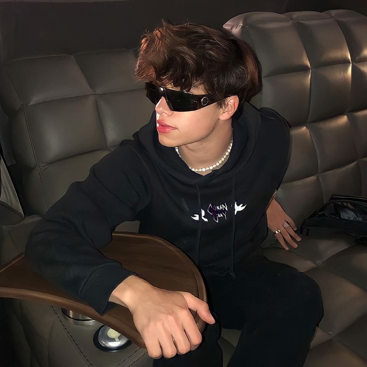 a person sitting in a car wearing sunglasses