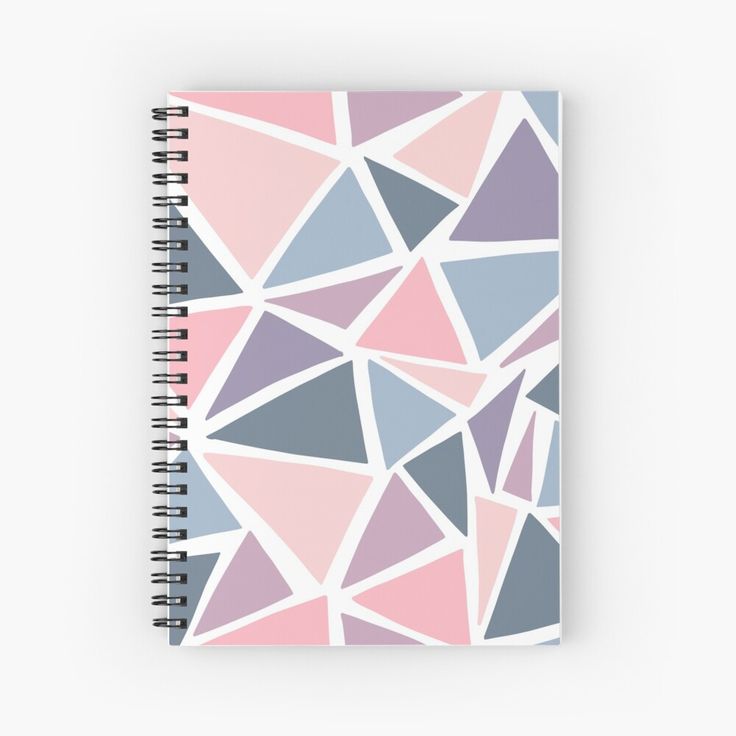 a spiral notebook with pink, blue and grey triangles