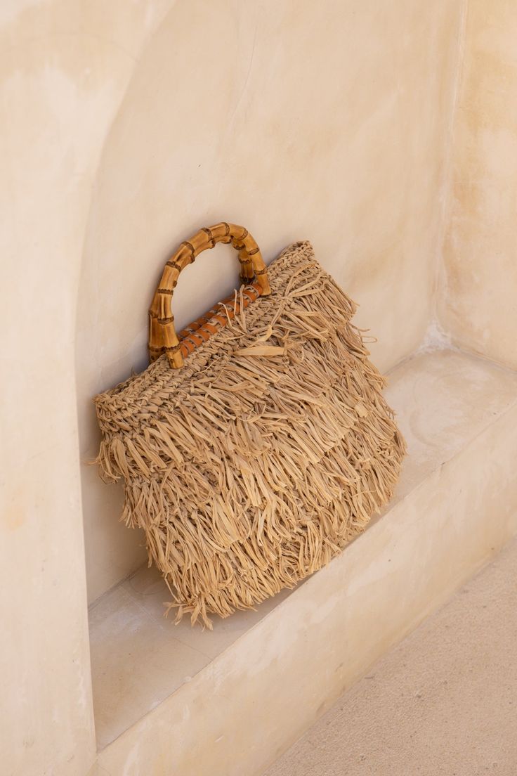 Expertly crafted by Lusana, the Aylin Fringe Basket Tote blends straw and trendy fringe accents to create a stunning design. Featuring an open top and adorned with faux bamboo wood-tone handles and leather trim details, this bag is perfect for your next European getaway. Trendy Fringe, Crochet Carpet, Basket Tote, Mini Accessories, Macrame Bag, Belly Chain, Faux Bamboo, Crochet Bags, Market Bag