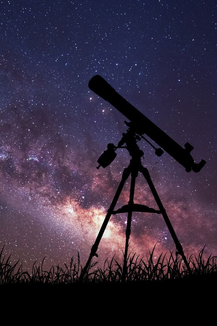 a telescope on top of a tripod in front of a night sky filled with stars