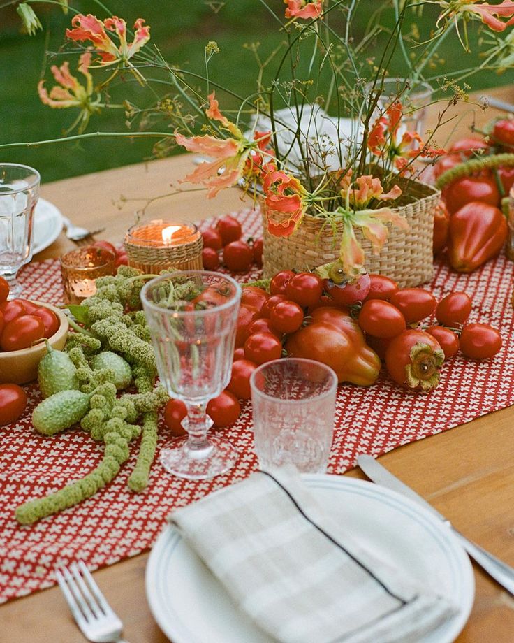 the table is set with tomatoes and other vegetables