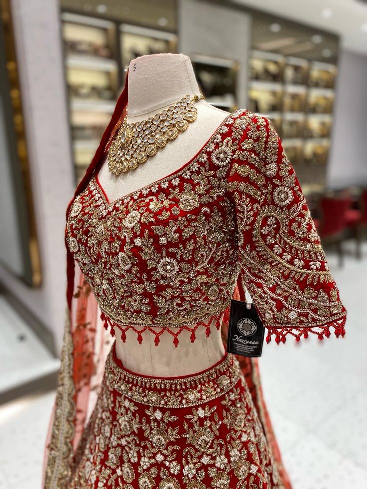 This bright red bridal lehenga BL-134 is the perfect choice for your big day. The intricate detailing of pearls, blush pink and gold stones adds a touch of elegance to the traditional design. Expertly crafted, this lehenga is sure to make you stand out and shine on your special day! Fabric: Velvet! WASH CARE INSTRUCTIONS - Please Dry clean only when it is applicable! Ready to Ship! Bright Colour Lehenga Designs, Bridal Red Lehenga, Red Lehenga Bridal, Indian Bridal Wear Red, Red Bridal Lehenga, Cutdana Embroidery, Bridal Lehenga Red, Saree Designs Party Wear, Red Lehenga