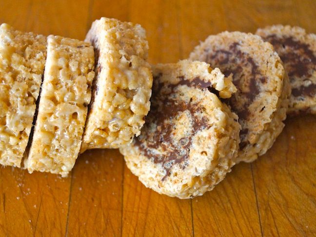 three cookies stacked on top of each other on a wooden table with one cookie cut in half