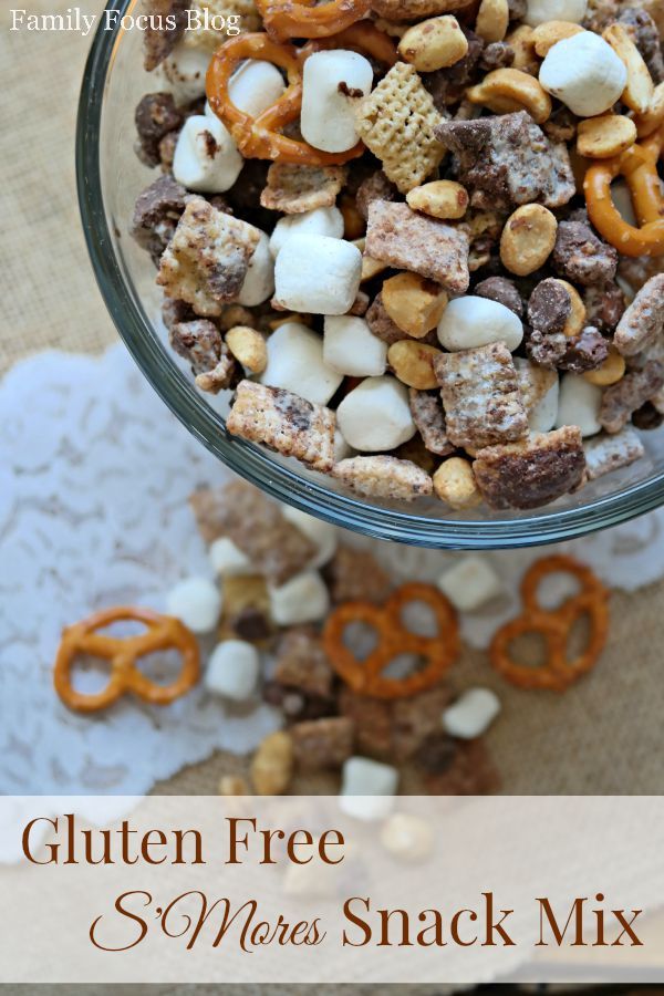 a glass bowl filled with cereal and pretzels