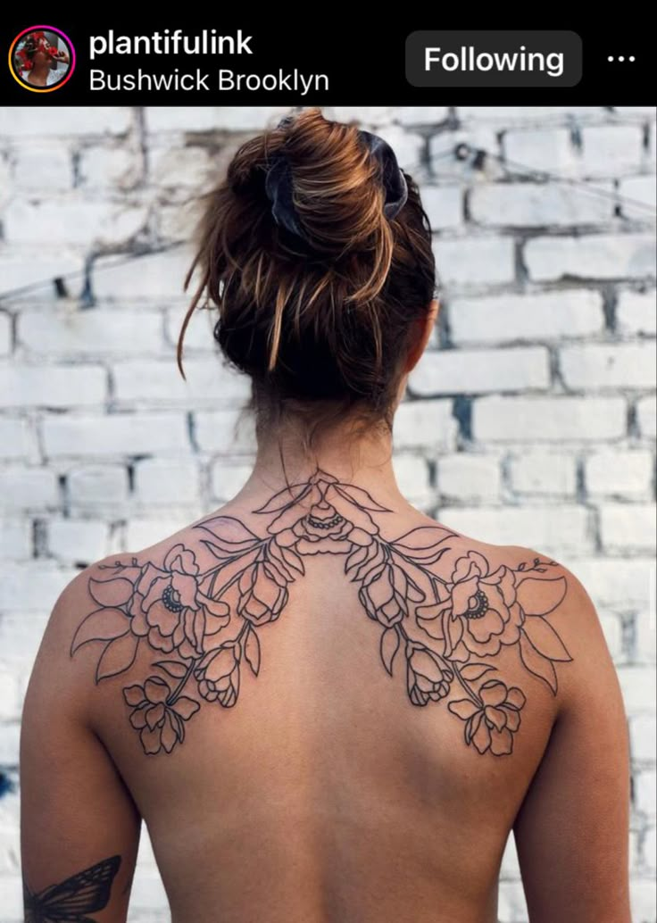 the back of a woman's neck with flowers and butterflies tattooed on her chest