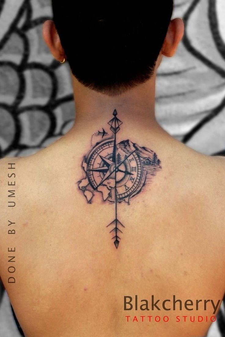 a man with a compass tattoo on his back