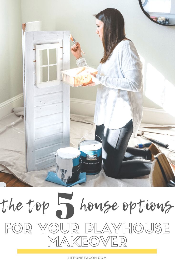 a woman sitting on the floor in front of an open door with paint and supplies around her