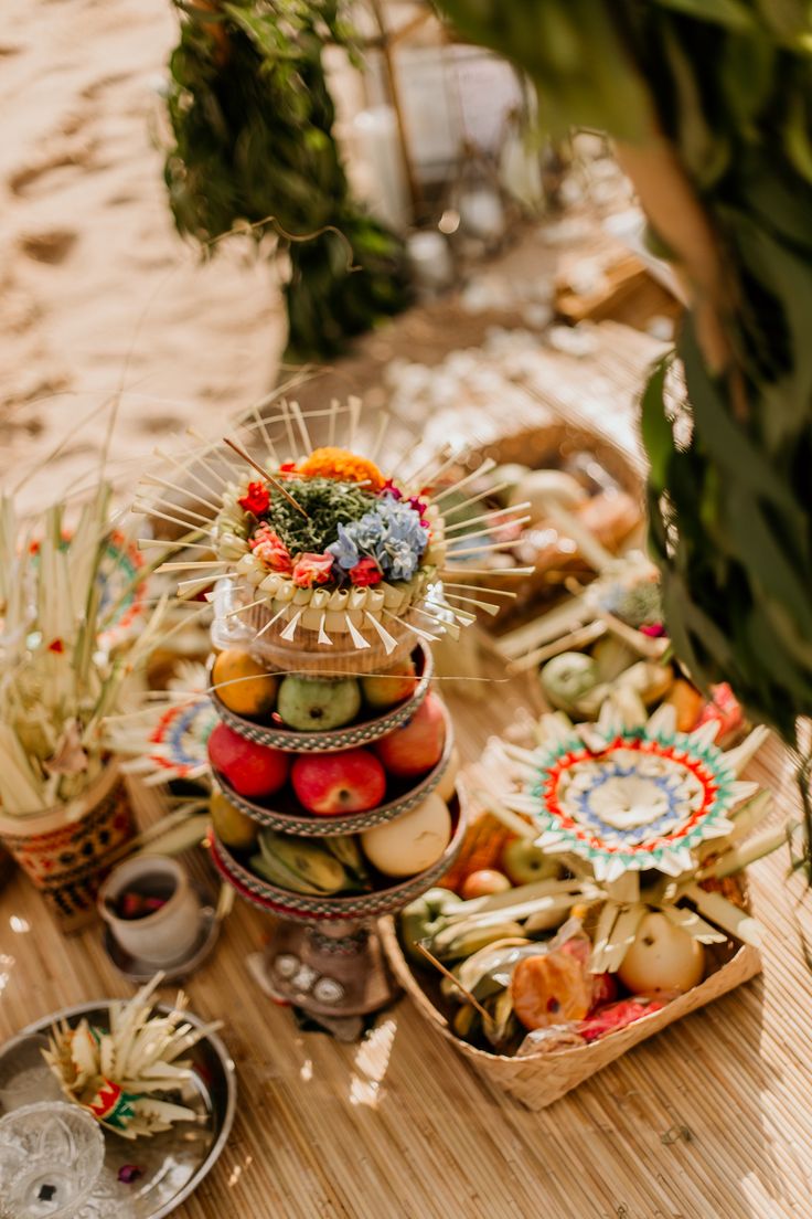 an assortment of fruits and vegetables on a table with other food items in the background