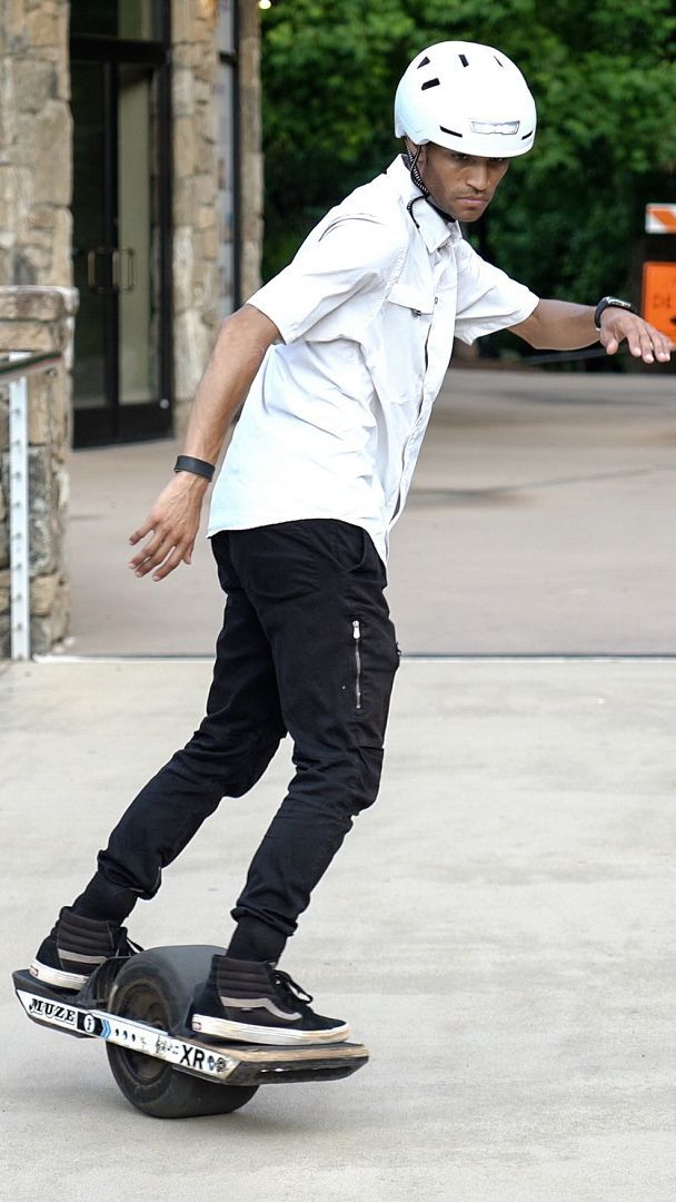 a man riding a skateboard on top of a cement slab in front of a building