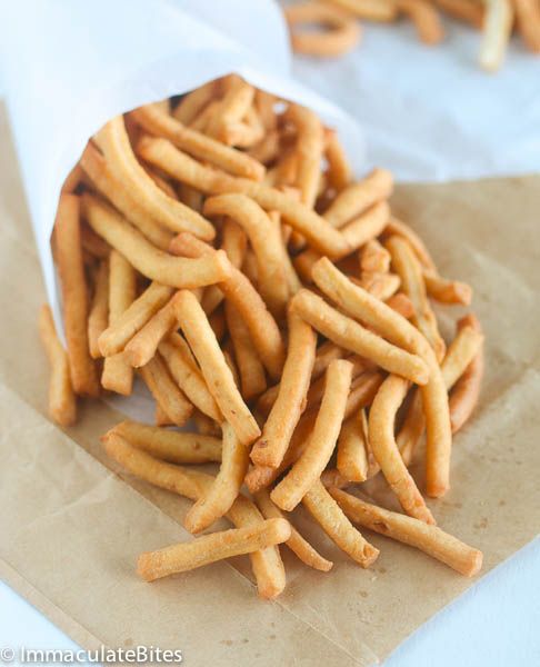 a pile of french fries sitting on top of a piece of paper