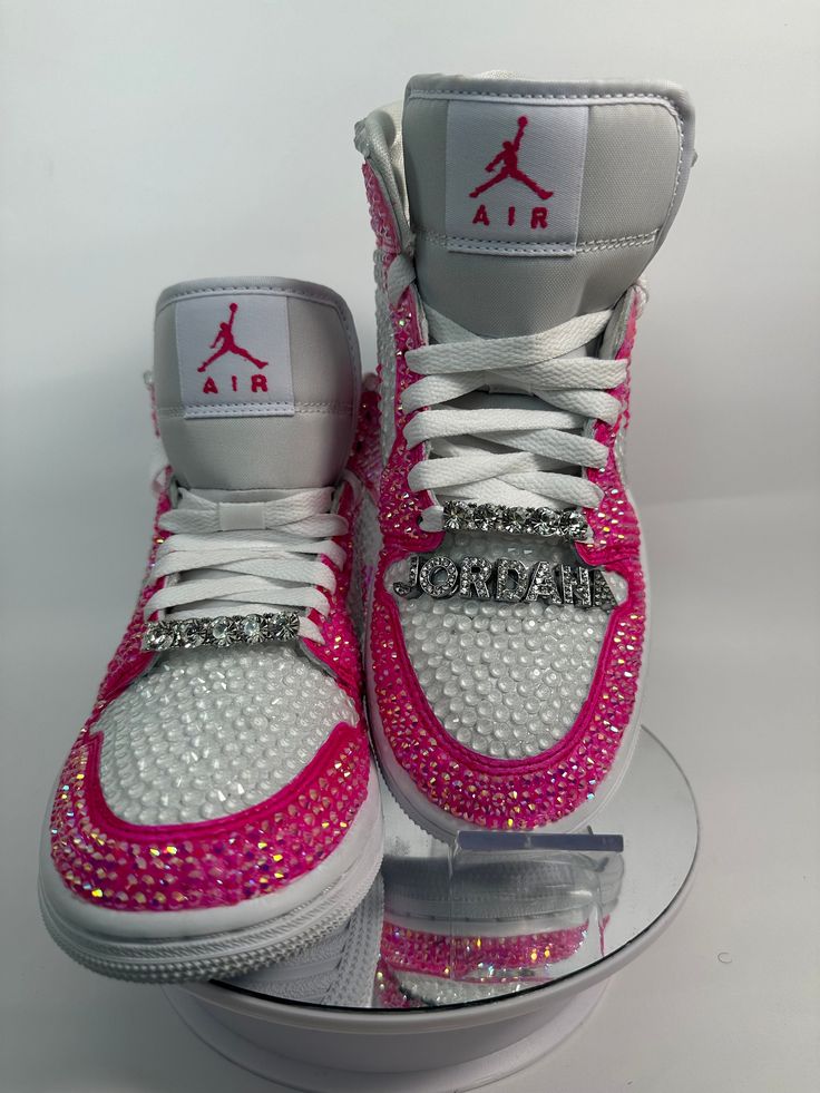 Step up your sneaker game with some fully blinged Jordan 1 mids. These shoes are a great addition for prom, a birthday, a wedding, a night on the town, or your  next event! These shoes can be customized to the colors of your choosing. Not looking for Jordan 1's? Message me with your shoe choice. I'd love to create the custom shoe of your dreams. Please note, shoe charms are not included in the listing but are available as a bonus add on. Please see my listing entitled EXTRAS to add shoe charms.  *Disclaimer We are not associated with the brand, I only hand customize the shoes using rhinestones. Nike Rosa, Rhinestone Sneakers, Jordan 1 Mids, Casual Shoes Women Sneakers, Bedazzled Shoes, Nike Shoes Women Fashion, Pretty Sneakers, Custom Rhinestone, Nike Fashion Shoes