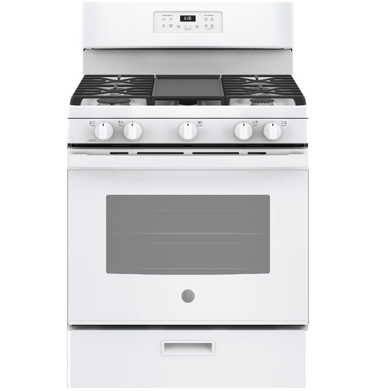 a white stove top oven sitting on top of a counter next to an oven door