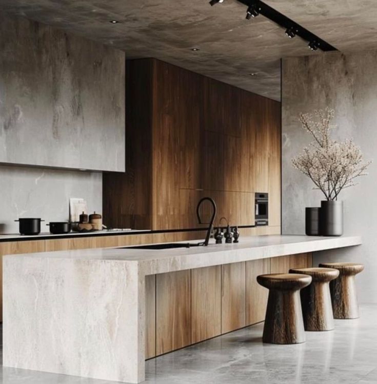 a modern kitchen with marble counter tops and wooden cabinetry, along with stools