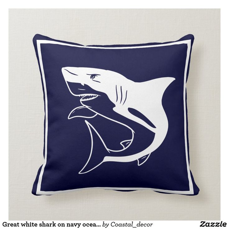 a blue and white pillow with a shark on it