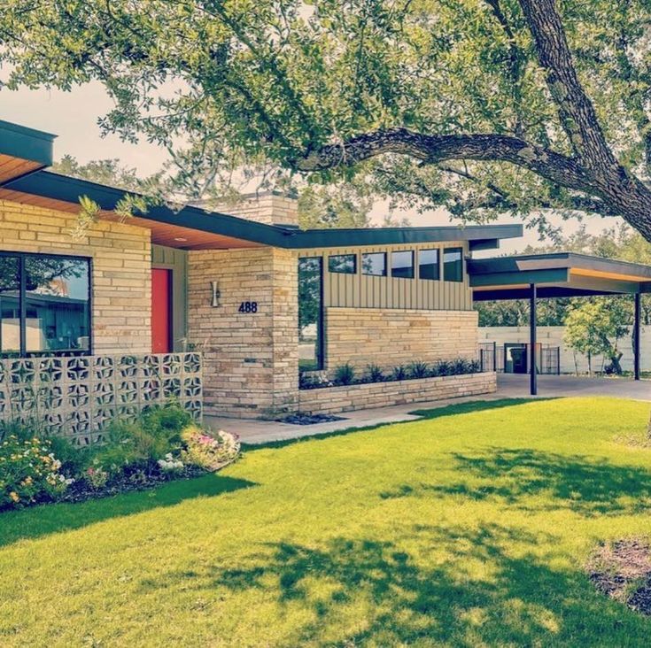 a house with trees and grass in front of it