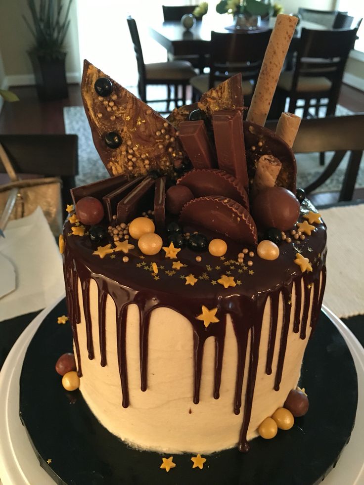 a cake with chocolate icing and stars on it sitting on top of a plate