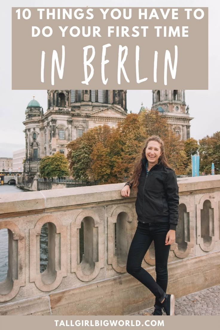 a woman standing on a bridge with the words 10 things you have to do your first time in berlin