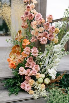 a bunch of flowers that are on some steps