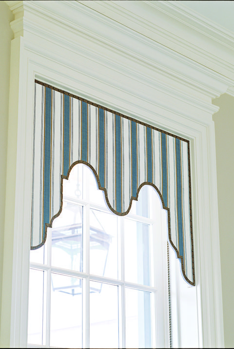 a window with a blue and white striped valance hanging from it's side