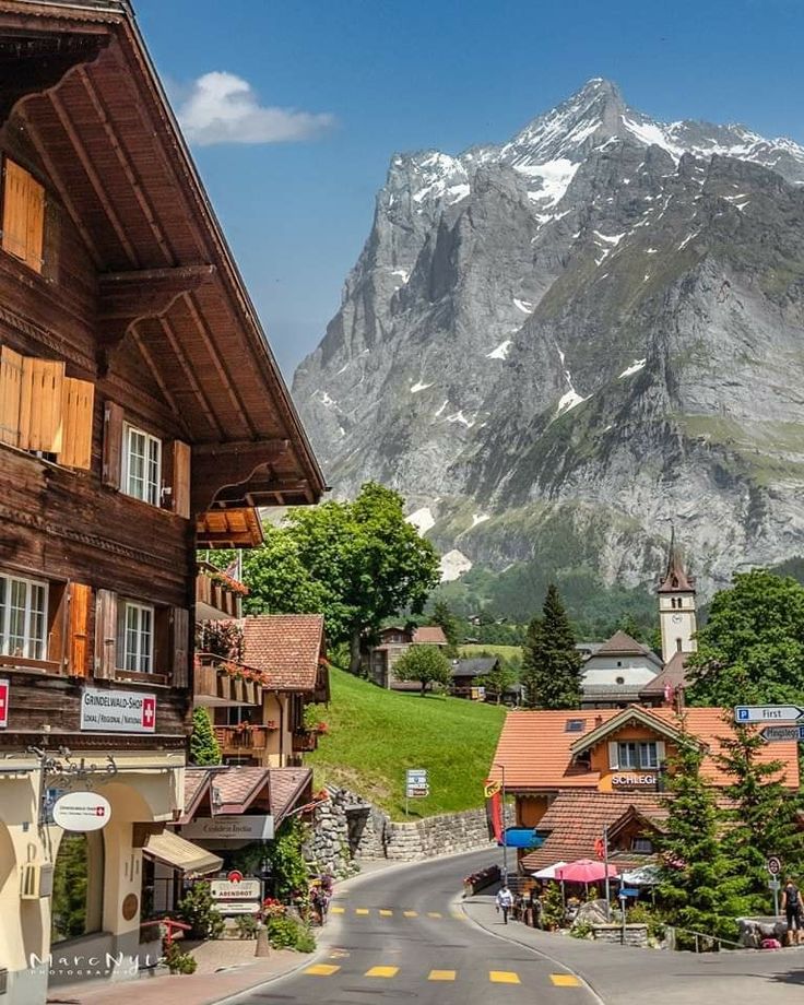 an alpine village with mountains in the background