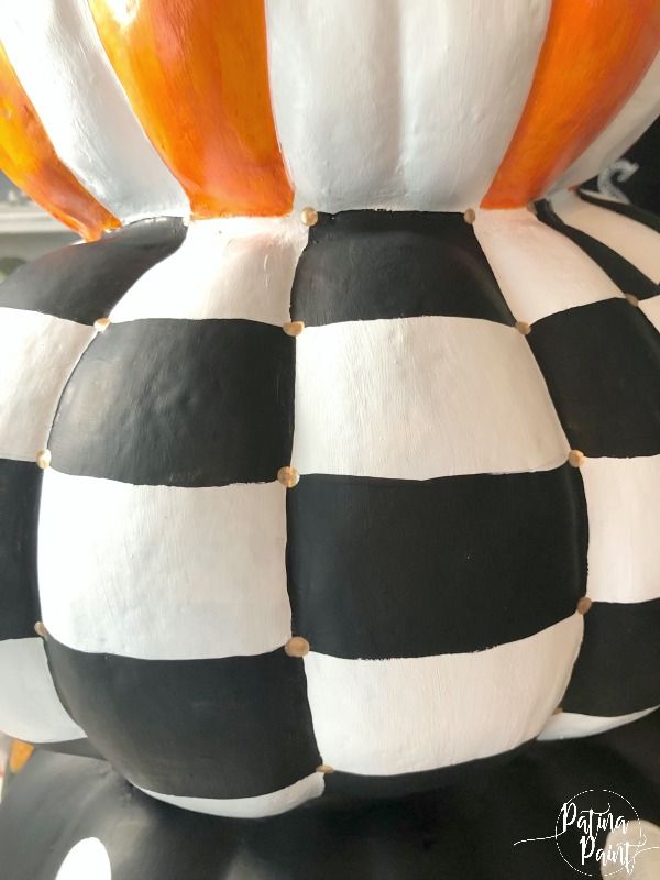 black and white striped pumpkins are stacked on top of each other in the shape of a ball