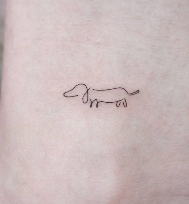 small dachshund tattoo on the ankle