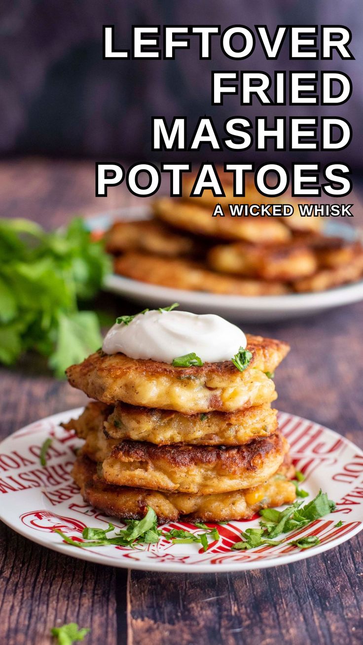 a stack of fried mashed potatoes on a plate with sour cream and parsley