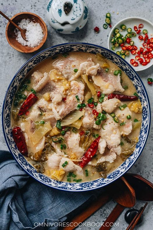 a blue and white bowl filled with food