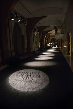 an empty hallway is lit up with light from the sun shining on it and there are no people