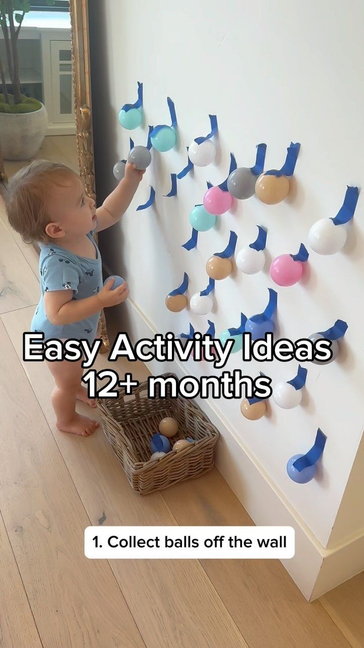 a baby standing in front of a wall with magnets on it and the words easy activity ideas for 12 months old