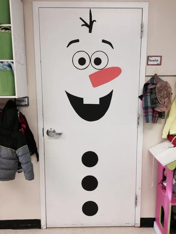 a door with a snowman face painted on the front and side doors, in a child's playroom