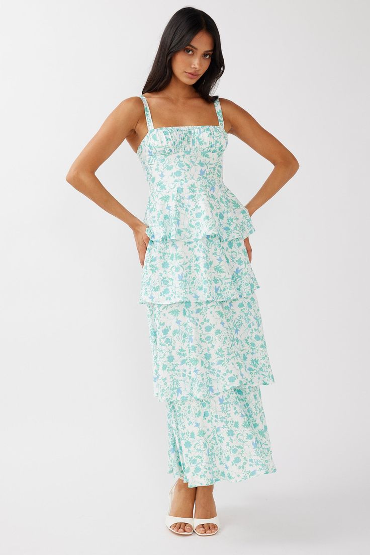 Floral green midi dress Lined Gathering in bust Tiered layers in skirt Tied, bow back Zipper in back Length: 54.8" You'll feel like running through fields of lavender in our gorgeous Provence Bloom midi dress. Perfect for a wedding or high tea birthday with your besties. Team it with white kitten heels and a clutch for a stunning look that will have everyone asking, "Where did you get your dress?!" MODEL INFO Model is wearing size XS Height: 5'7" Bust: 31.5" Waist: 23.5" Hips: 30" CARE Hand Wash White Kitten Heels, Midi Dress Floral, White Kitten, Yellow Bridesmaids, Tiered Midi Dress, Blue Bridesmaids, Iron Material, Date Night Dresses, Mini Dress Casual