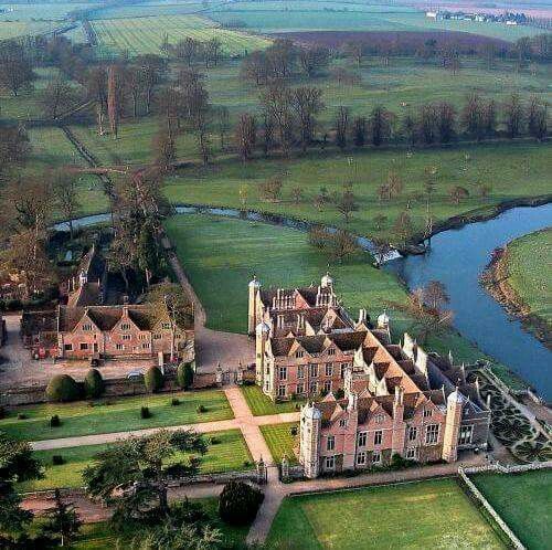 an aerial view of a large building with lots of grass