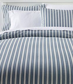 a bed with blue and white striped sheets