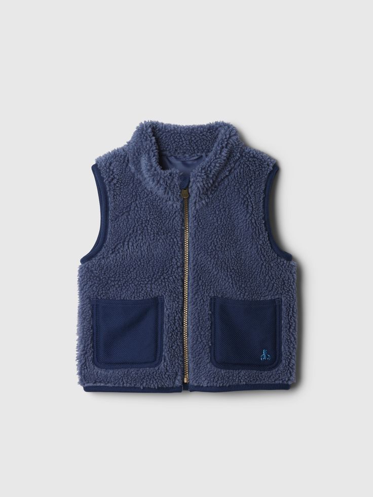 Soft sherpa vest.  Mockneck.  Sleeveless.  Zipper front.  Patch pockets at front.  Embroidered Brannan Bear at pocket.  This vest is made with 20% recycled polyester.  Compared to virgin materials, using recycled materials helps to reduce resource use and waste.  This product was made in a factory that invests in gender equality and women’s empowerment.  Through RISE Reimagining Industry to Support Equality) and Gap Inc. ’s program P. A. C. E.  Personal Advancement & Career Enhancement), we support people who make our clothes to build the skills, knowledge, confidence, and resilience needed to advance in work and life.  Learn more here.  Straight, easy fit.  Hits at the hip.  Sizes range from baby to toddler. Sherpa Vest, Gender Equality, Support People, Christmas 2024, Holidays With Kids, Baby Gap, Recycled Materials, Front Zipper, Mock Neck