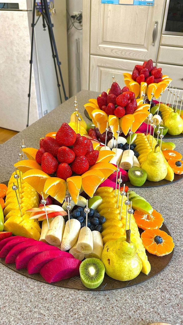 fruit is arranged in the shape of an umbrella on a kitchen counter with other fruits