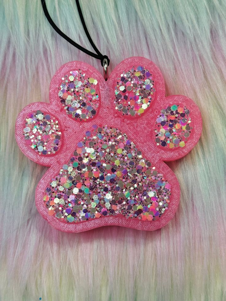 a pink dog paw with glitter on it