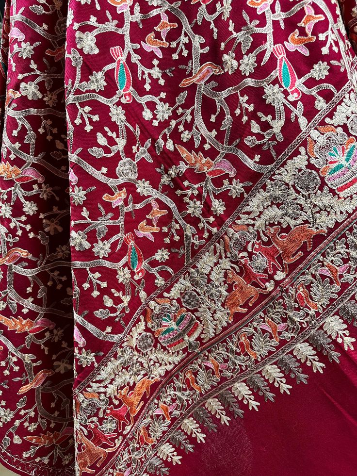 A Kashmiri Shawl adorned with intricate and fine Nalki Ari embroidery work, delicately crafted by skilled artisans. The scarf features exquisite patterns and motifs of birds meticulously stitched using the traditional Nalki Ari technique, showcasing the rich cultural heritage of Kashmiri craftsmanship. Each thread and stitch is carefully placed, creating a beautiful and timeless piece of wearable art that reflects the region's legacy of intricate embroidery and attention to detail. Approximate m Festive Scarves With Traditional Patterns And Drape, Festive Shawl With Traditional Patterns, Eid Wedding Pashmina Shawl, Wedding Eid Pashmina Shawl, Intricate Embroidered Wedding Scarf In Traditional Drape, Pashmina Shawl For Eid Weddings, Traditional Wedding Scarves With Motifs, Wedding Scarves With Intricate Embroidery In Traditional Drape, Festive Shawl Scarves With Traditional Patterns