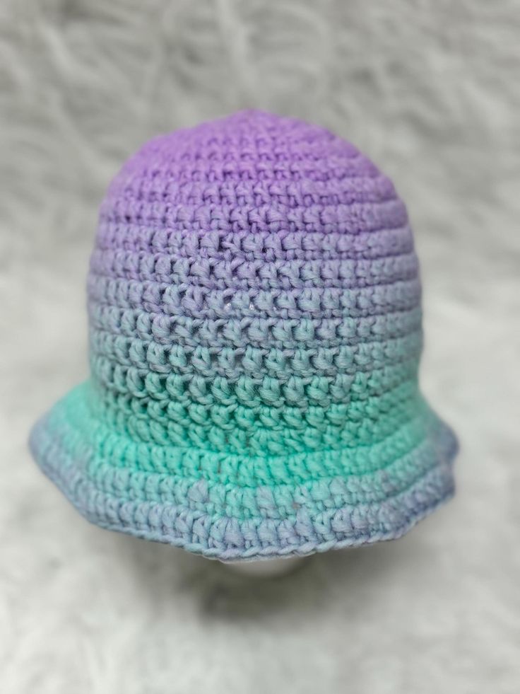 Elevate your style with a handcrafted crochet bucket hat! This trendy and versatile accessory is perfect for any season, offering a chic blend of fashion and function. Made with love and attention to detail, the Unicorn bucket hat adds a playful yet sophisticated touch to your wardrobe. Key Features: Materials: Soft, breathable acrylic yarn that provides comfort and durability. Design: Timeless bucket hat silhouette with a unique crochet texture, available in a range of colors to suit any outfit. Fit: One size fits most, designed to comfortably fit and frame your face. Care: Easy to clean--simply hand wash and lay flat to dry to maintain its shape and vibrancy. Trendy Handmade Bucket Hat, Trendy Purple Bucket Hat With Curved Brim, Trendy Crochet Adjustable Hat, Trendy Crochet Hat With Short Brim, Trendy Purple Bucket Hat For Spring, Trendy Crochet Bucket Hat For Winter, Casual Crochet Mini Bucket Hat, Trendy Handmade Winter Bucket Hat, Trendy Handmade Wide Brim Bucket Hat