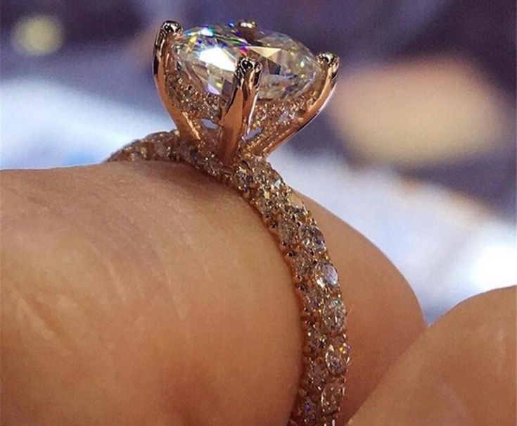 a close up view of a diamond ring on someone's finger with the center stone in