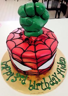 a spiderman birthday cake on a table