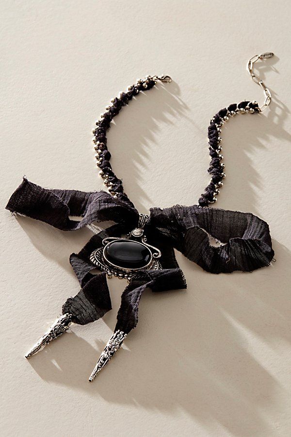 Add a head-turning touch to absolutely any look with this stand-out necklace featured in a textile-adorned chain design with defined pendant at center and exaggerated bow detail for an effortlessly edgy finishing touch. | Boca Bow Layer Necklace by Free People in Black Chic Metal Jewelry With Bow Detail, Black Bow Jewelry For Evening, Chic Party Jewelry With Ribbon Detail, Chic Party Jewelry With Ribbon, Black Jewelry With Ribbon For Evening, Black Ribbon Jewelry For Evening, Chic Evening Jewelry With Decorative Bow, Formal Jewelry With Black Ribbon, Adjustable Bow Jewelry For Evening