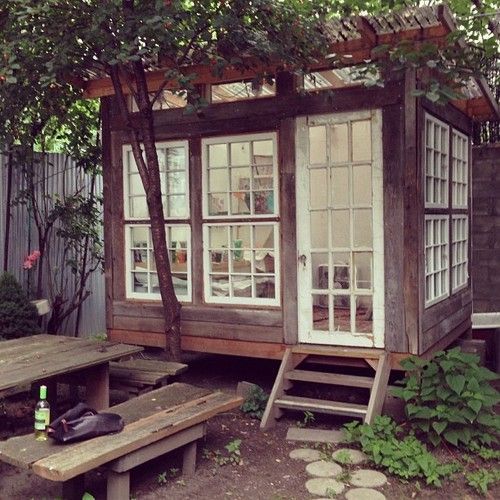 an image of a small wooden house with windows